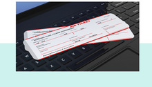 Two air tickets on a keyboard with a light blue border